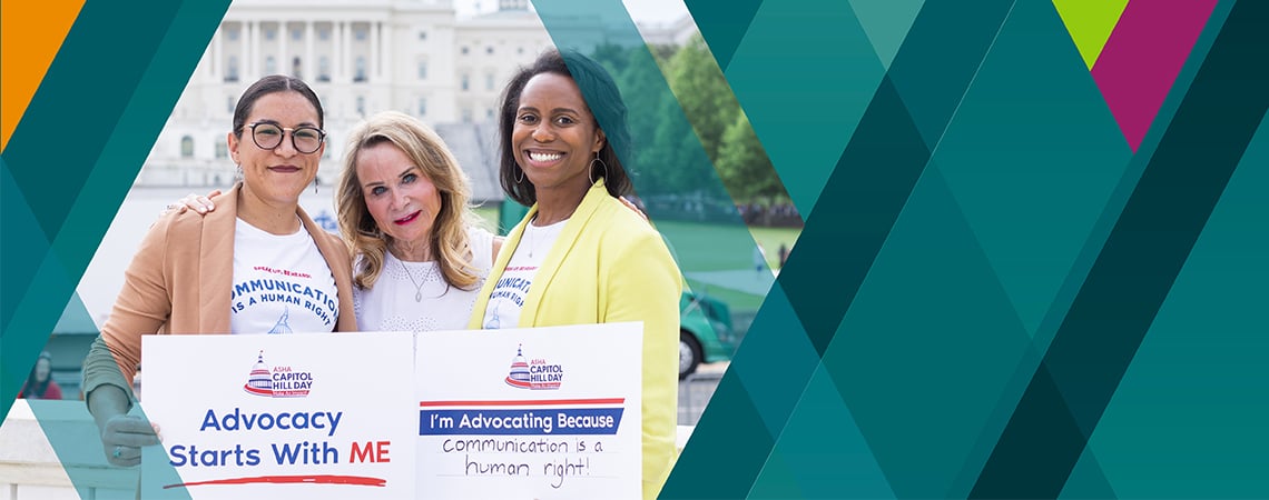 Three ASHA members by the U.S. Capitol building with signs: 